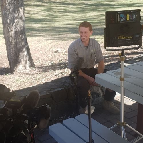 Peter Sutrin in front of camera, light and microphone